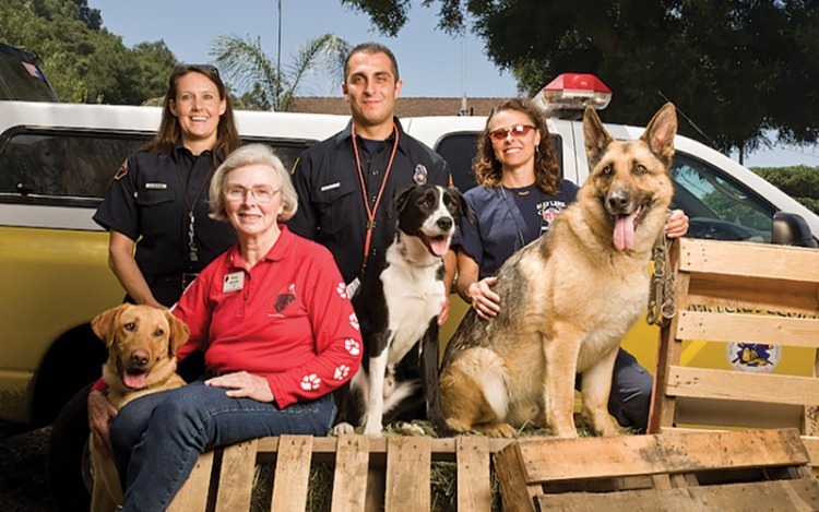 Wilma Melville (bottom left), founder of the Search Dog Foundation, and members of the disaster-search dog team.